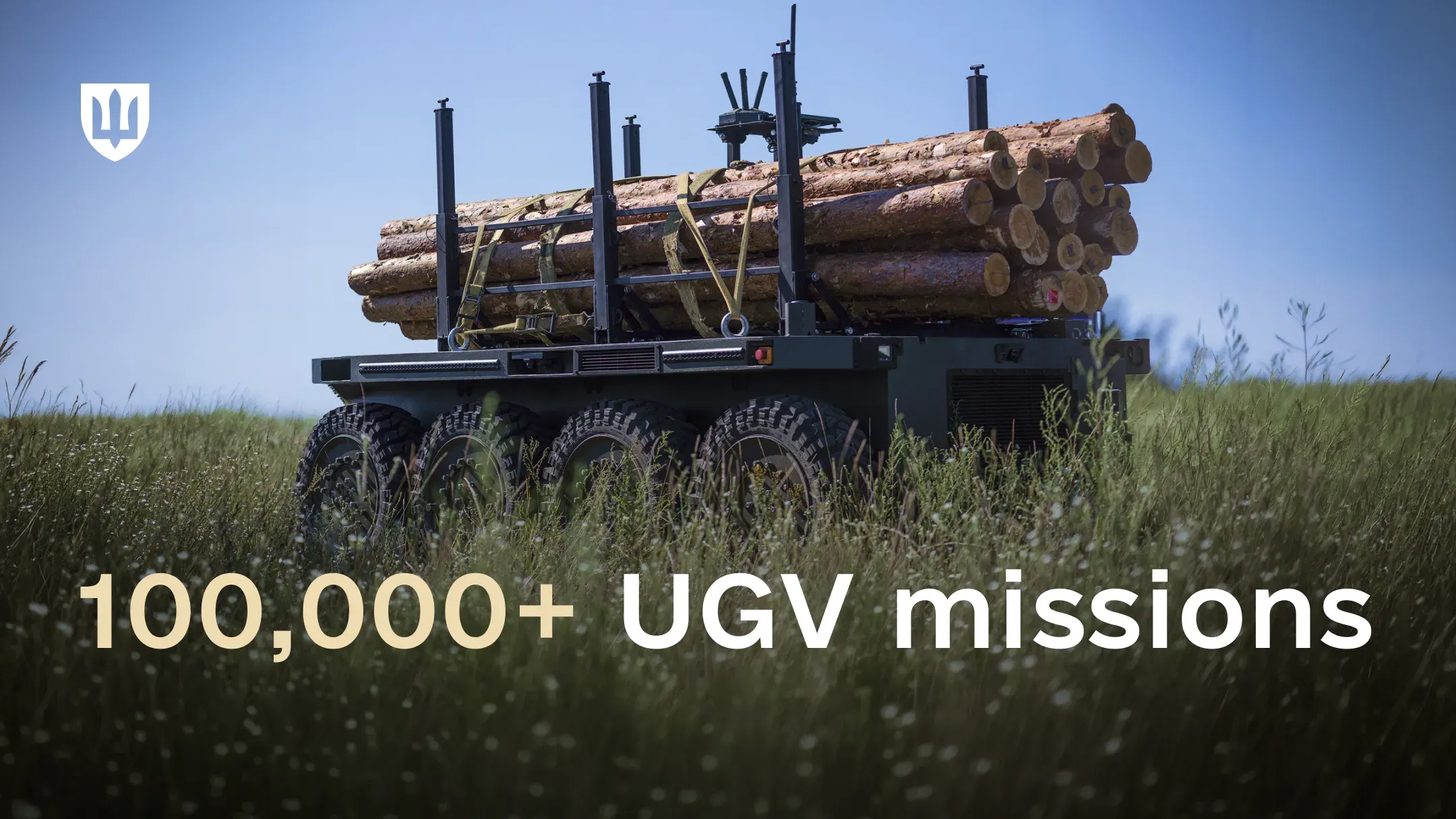 Unmanned ground vehicle loaded with logs in a grassy field