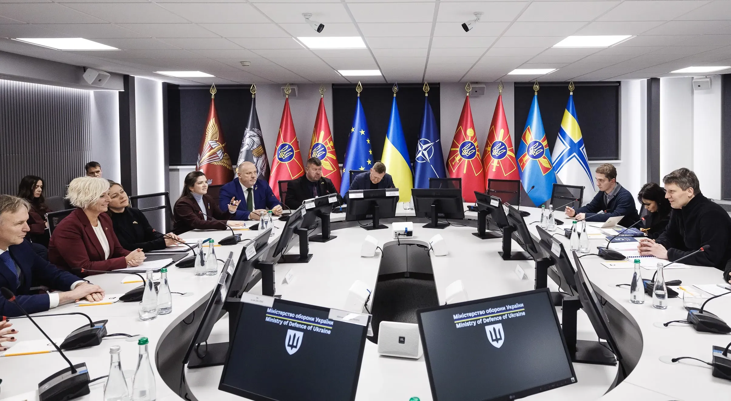 An official meeting at the Ministry of Defence of Ukraine, showing Deputy Minister of Defence Sergiy Boyev, Ministry representatives, and a foreign delegation led by Speaker of the Latvian Saeima Daiga Mieriņa seated at a large round table