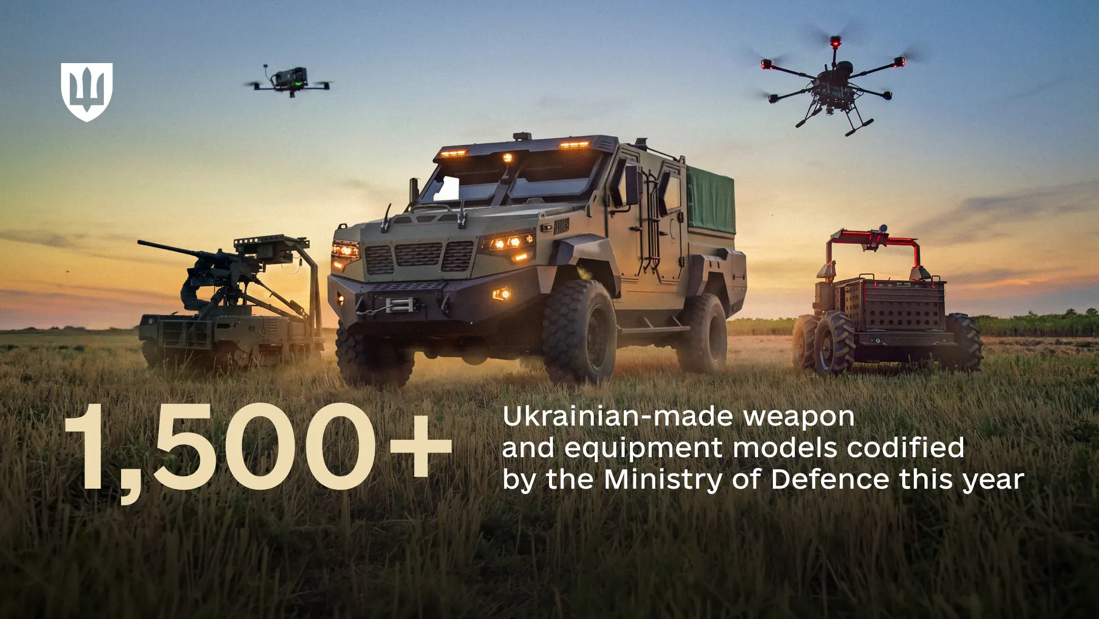 Various Ukrainian-made military vehicles and drones in a field at sunset