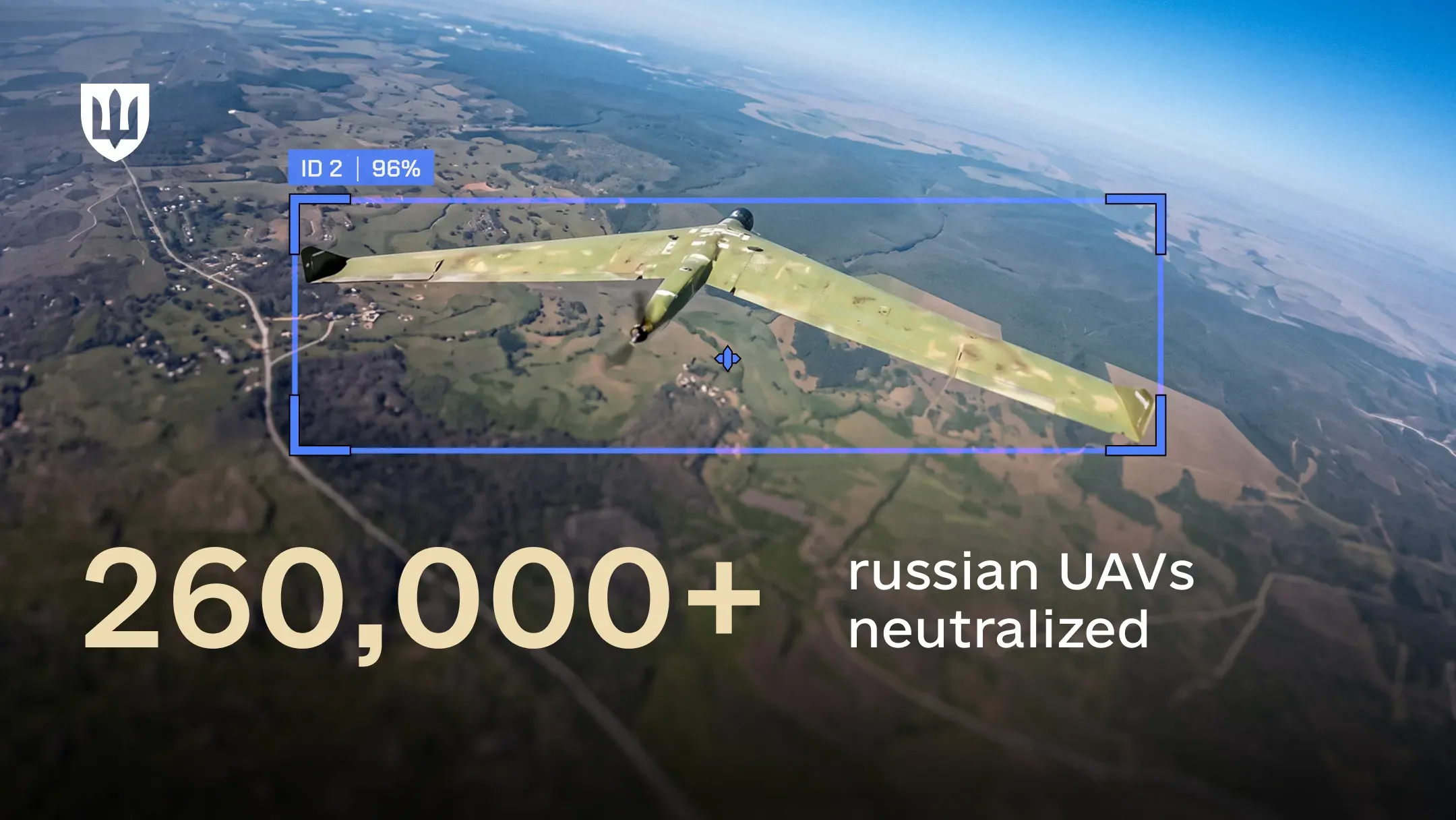 Fixed-wing UAV flying over terrain and framed by a tracking system