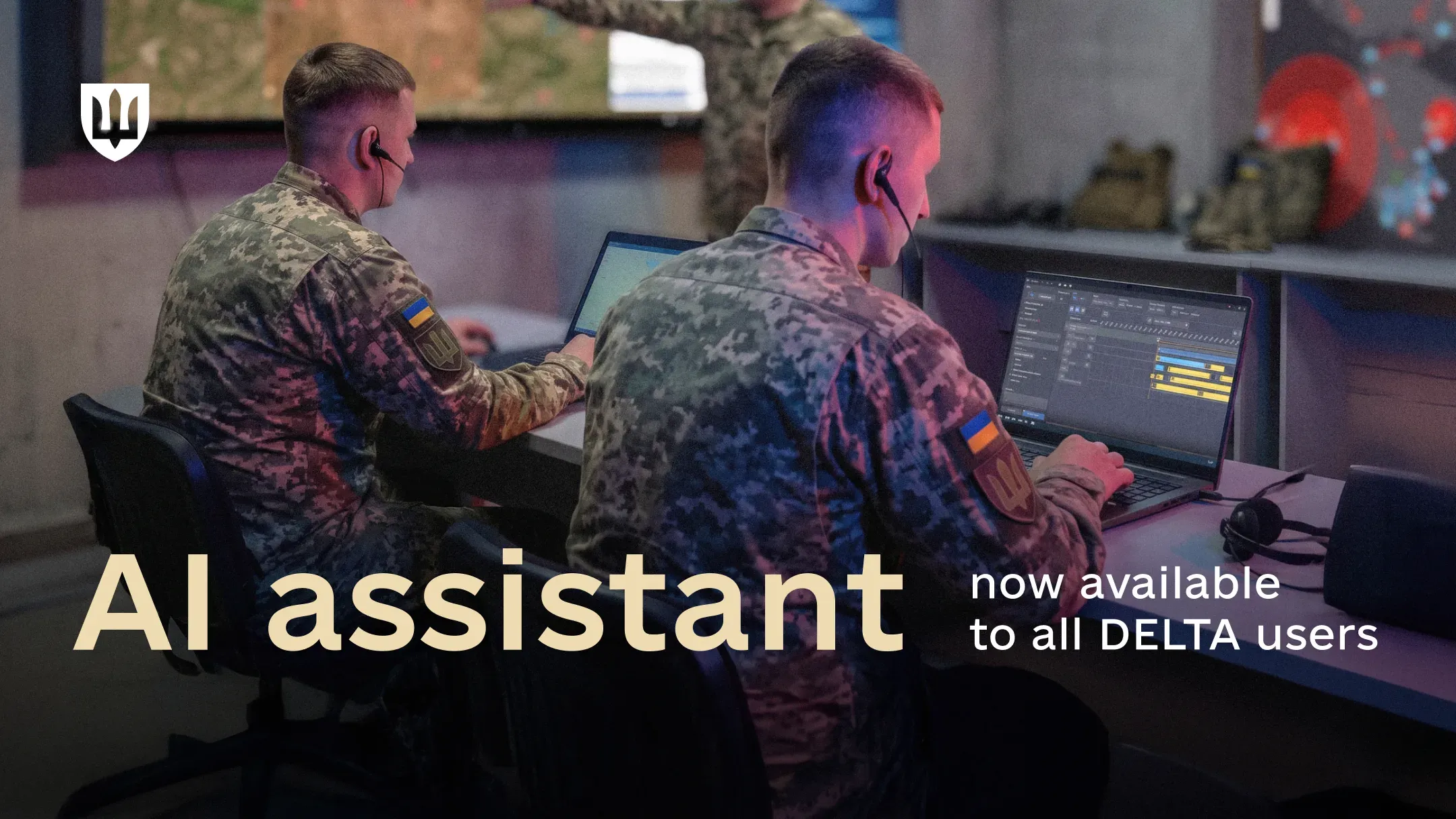 Two service members working on laptops indoors