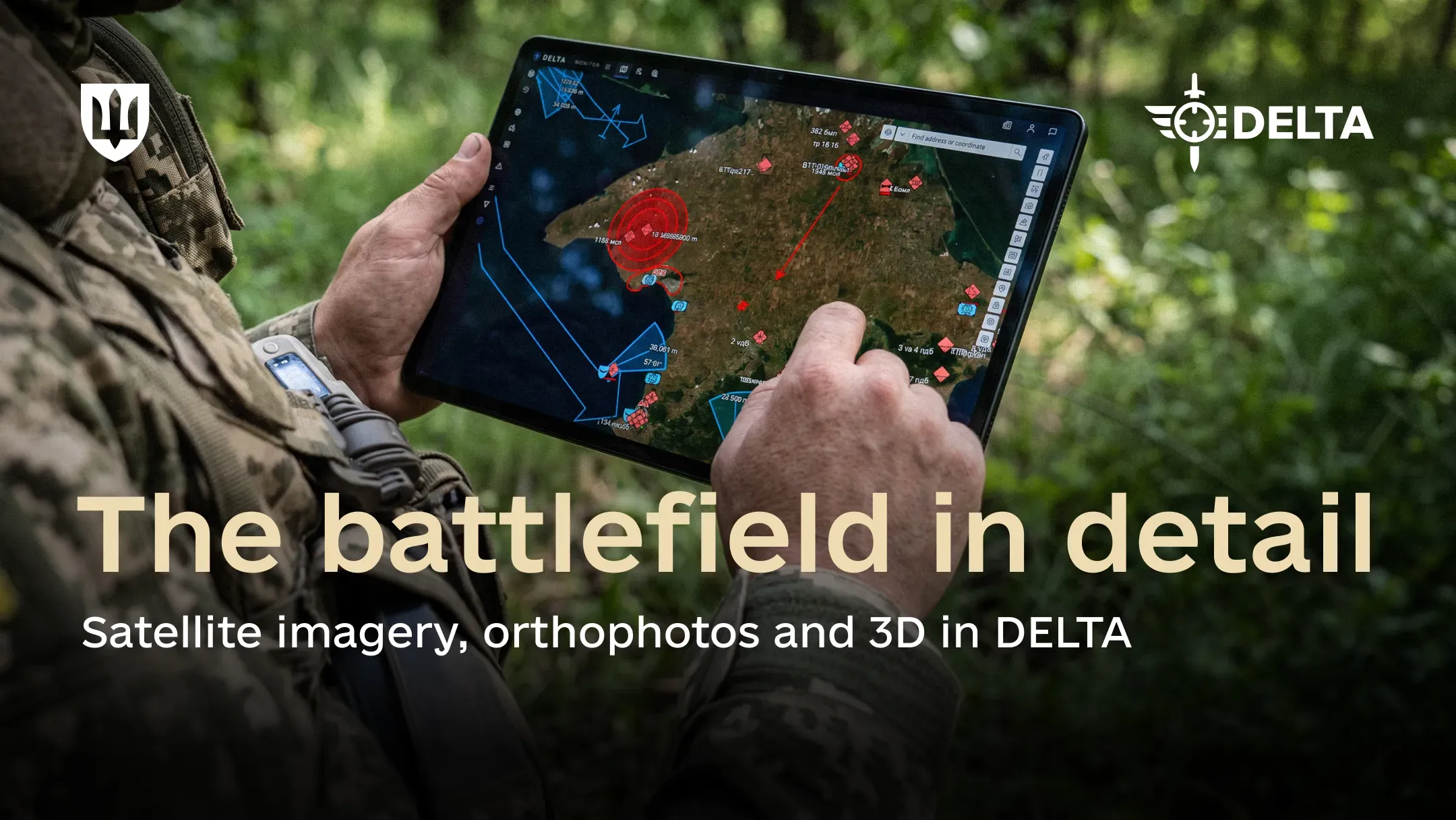 A service member holds a tablet displaying an interactive battlefield map, with greenery in the background