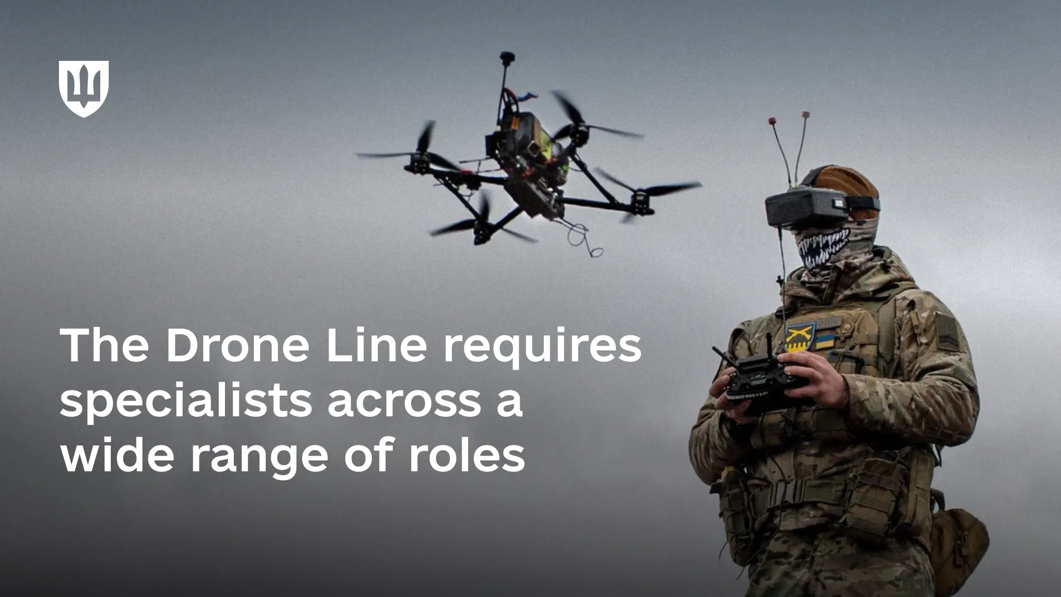 A military drone operator controls an FPV drone using a controller while wearing a specialized headset
