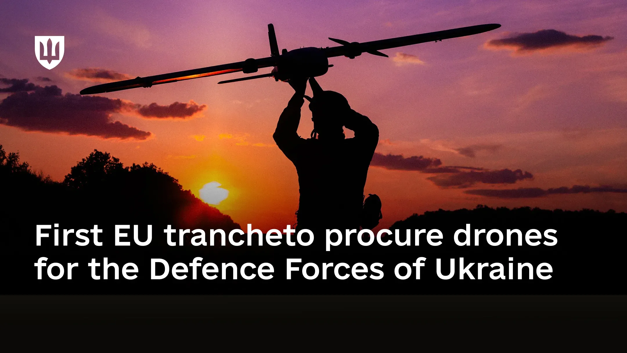 Silhouette of a service member holding a drone against the evening sky at sunset