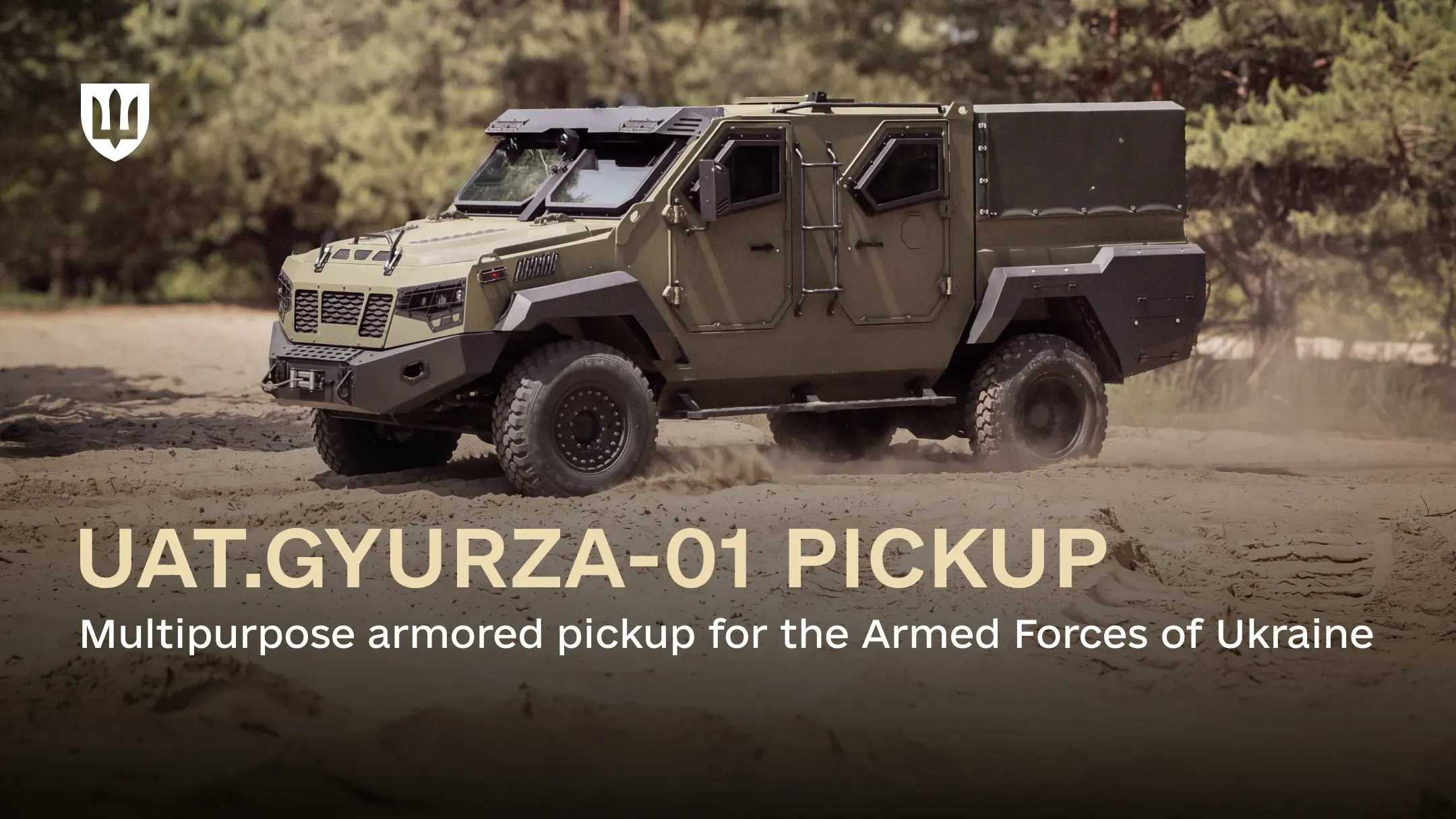 An armored UAT.GYURZA-01 PICKUP drives across sandy ground with a forest in the background