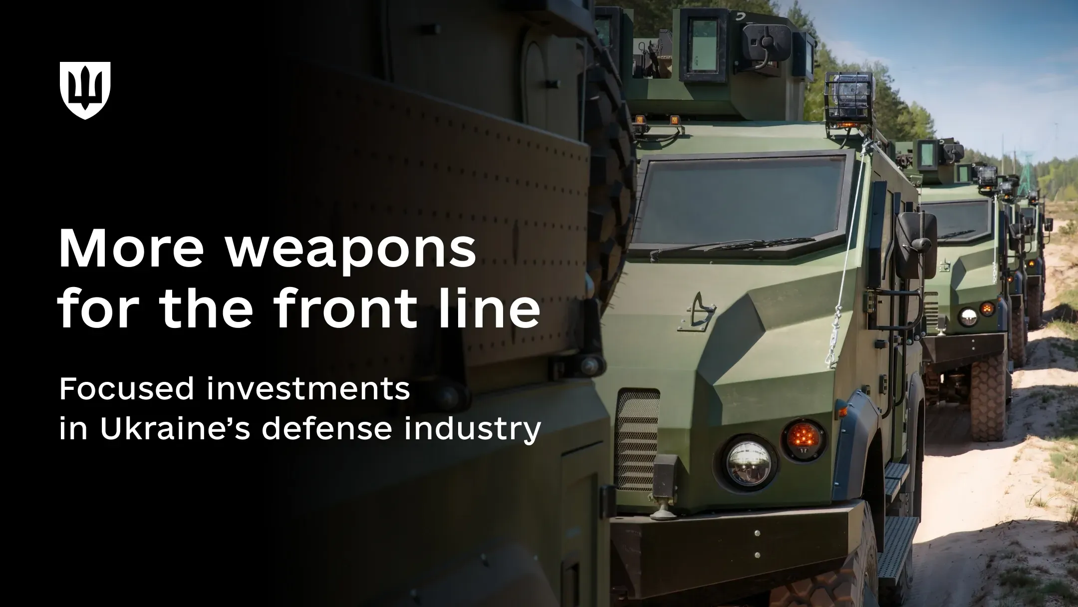A column of olive-green armored vehicles, similar to Kozak-2 vehicles, travels along an unpaved road through sparse woodland under a sunny sky. The vehicles are fitted with weapon stations, lighting systems, and other equipment.
