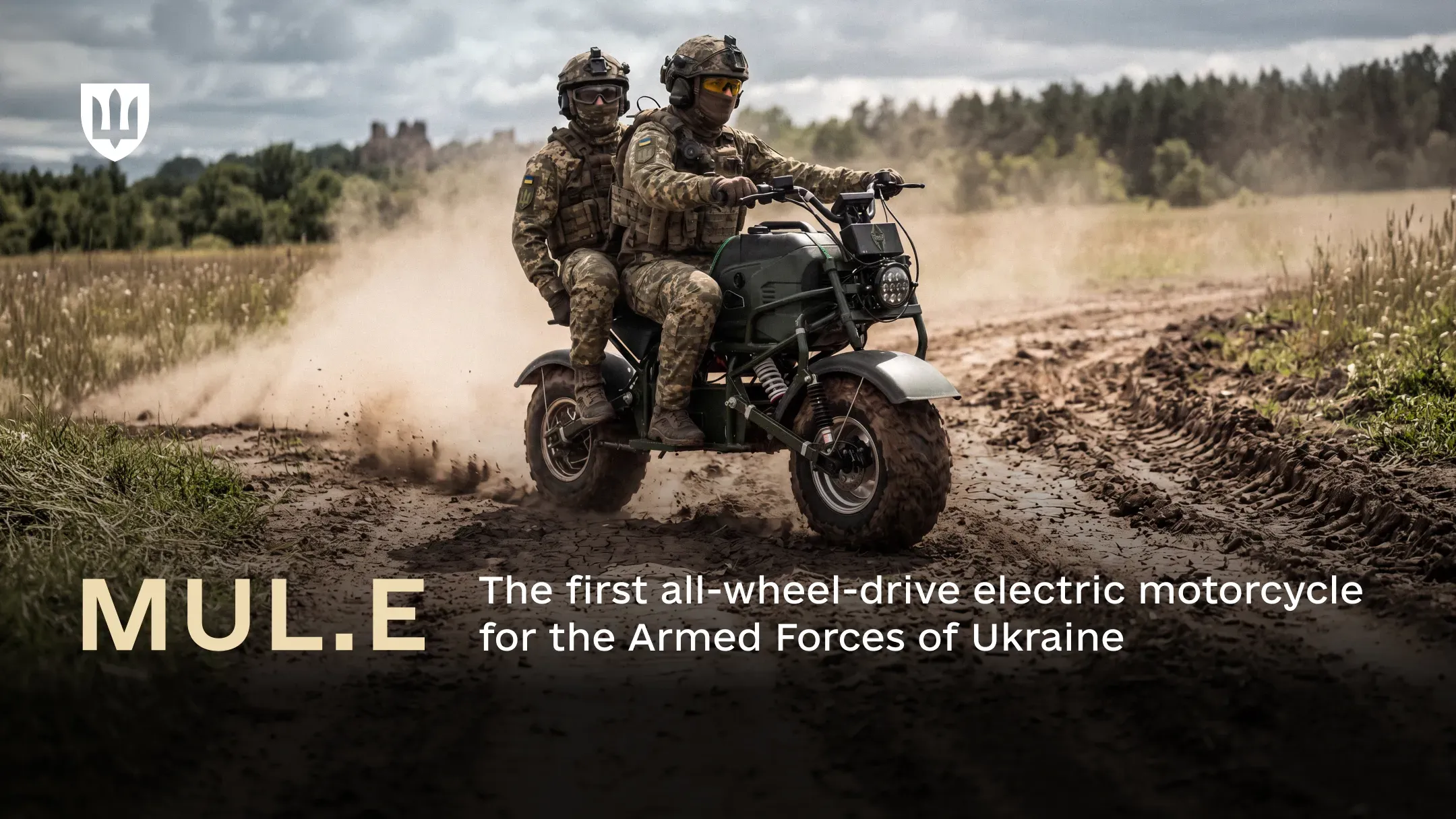 Two Ukrainian soldiers in camouflage and helmets riding the MUL.E electric motorcycle along a dirt road