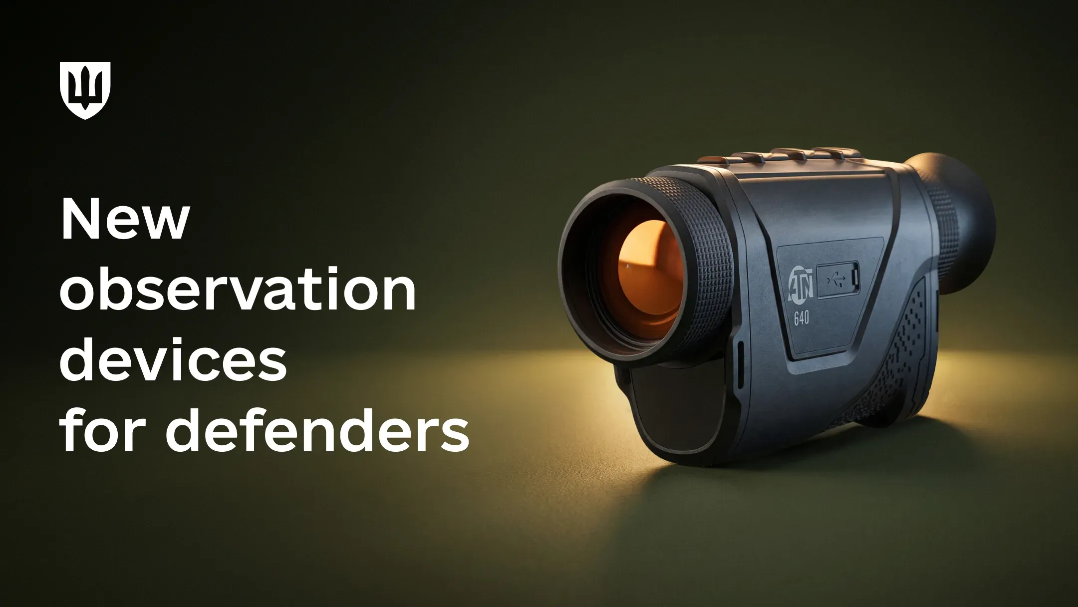ATND-TTM-640-50-LRF thermal monocular with an orange reflection on the lens against a dark green background