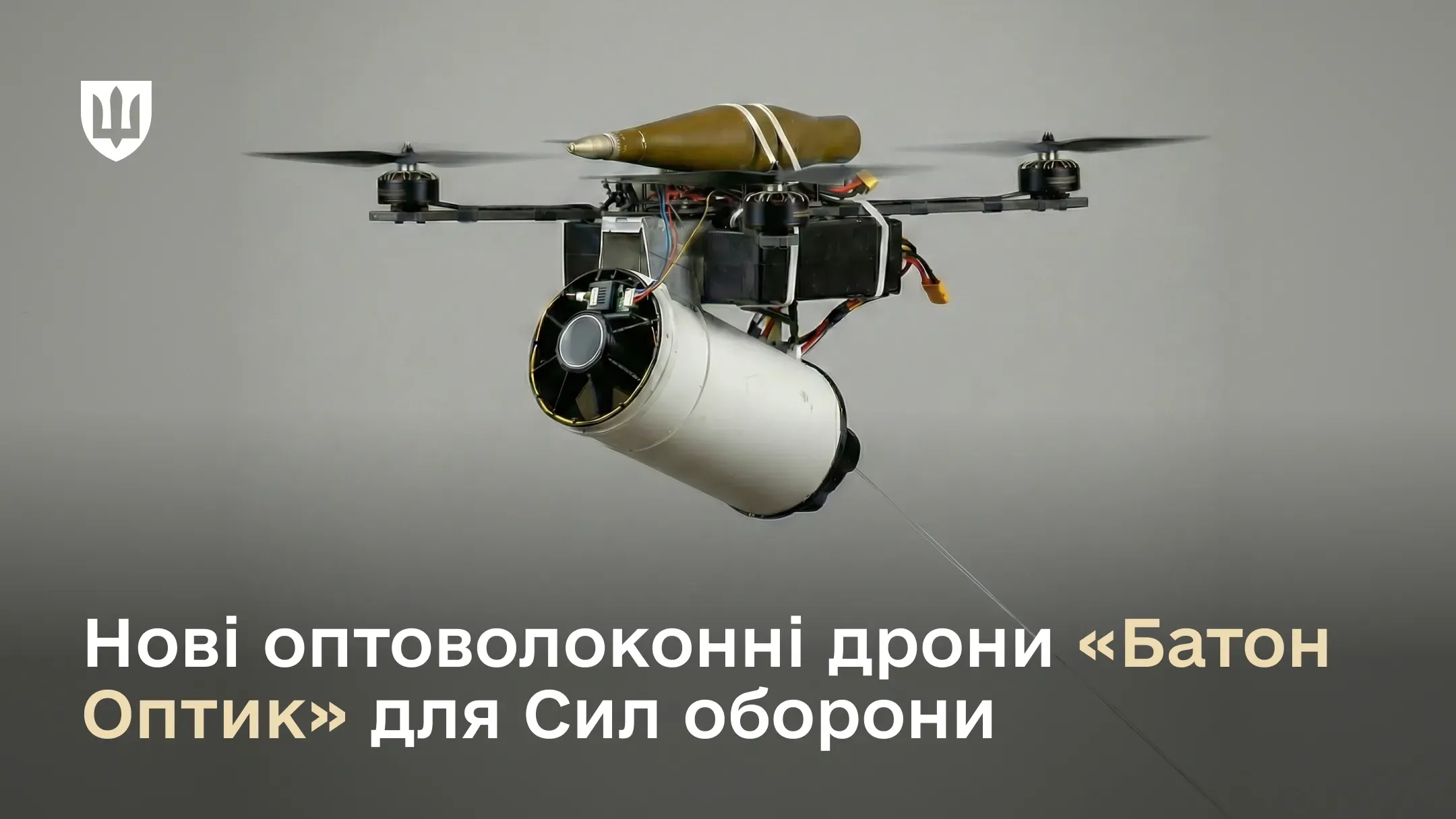 FPV-дрон «Батон Оптик» з прикріпленим боєприпасом та котушкою оптоволокна, що розмотується в польоті. Зображення на сірому фоні з написом «Нові оптоволоконні дрони "Батон Оптик" для Сил оборони».