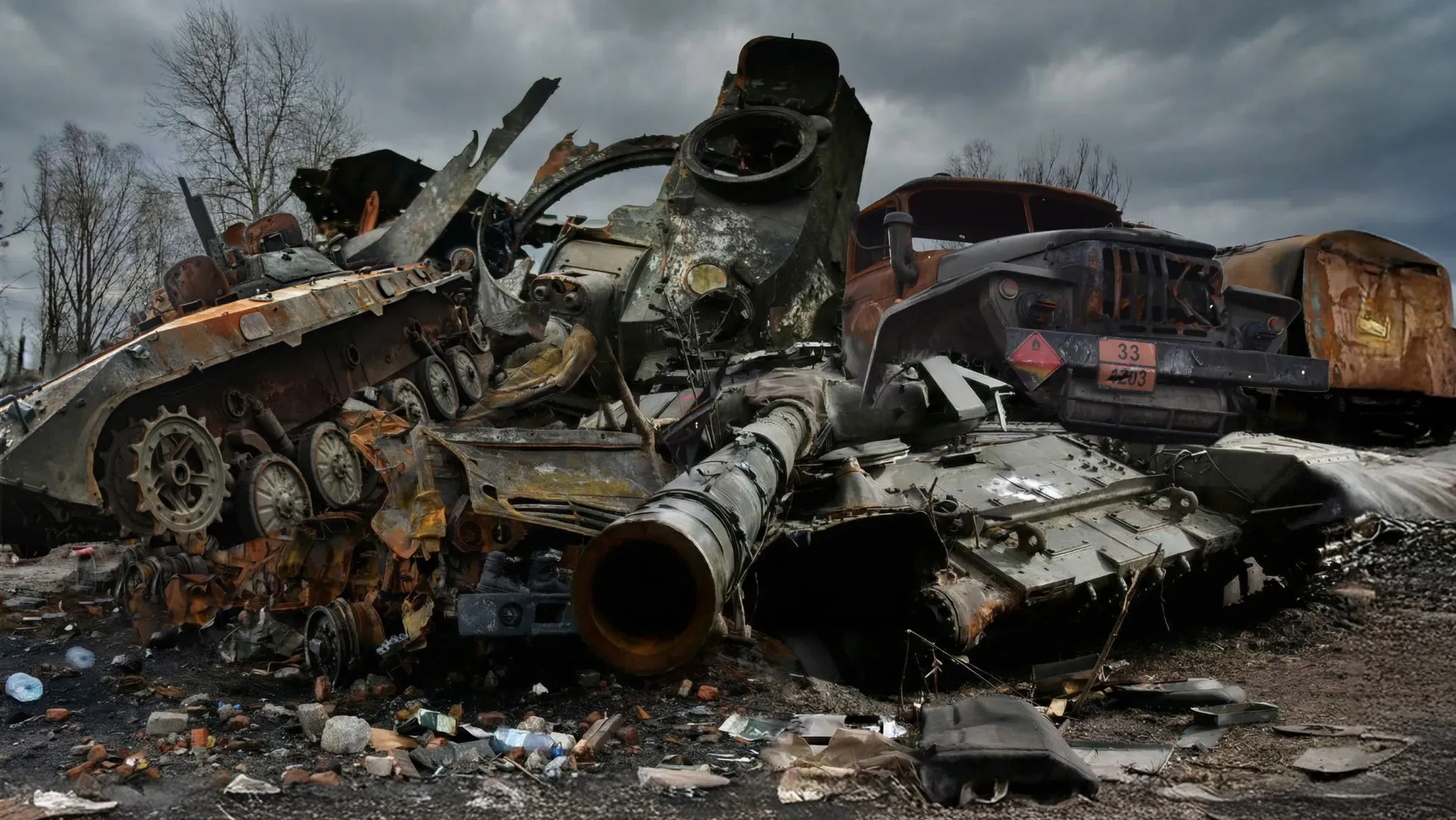 Destroyed and burned russian military vehicles against a backdrop of a gloomy sky