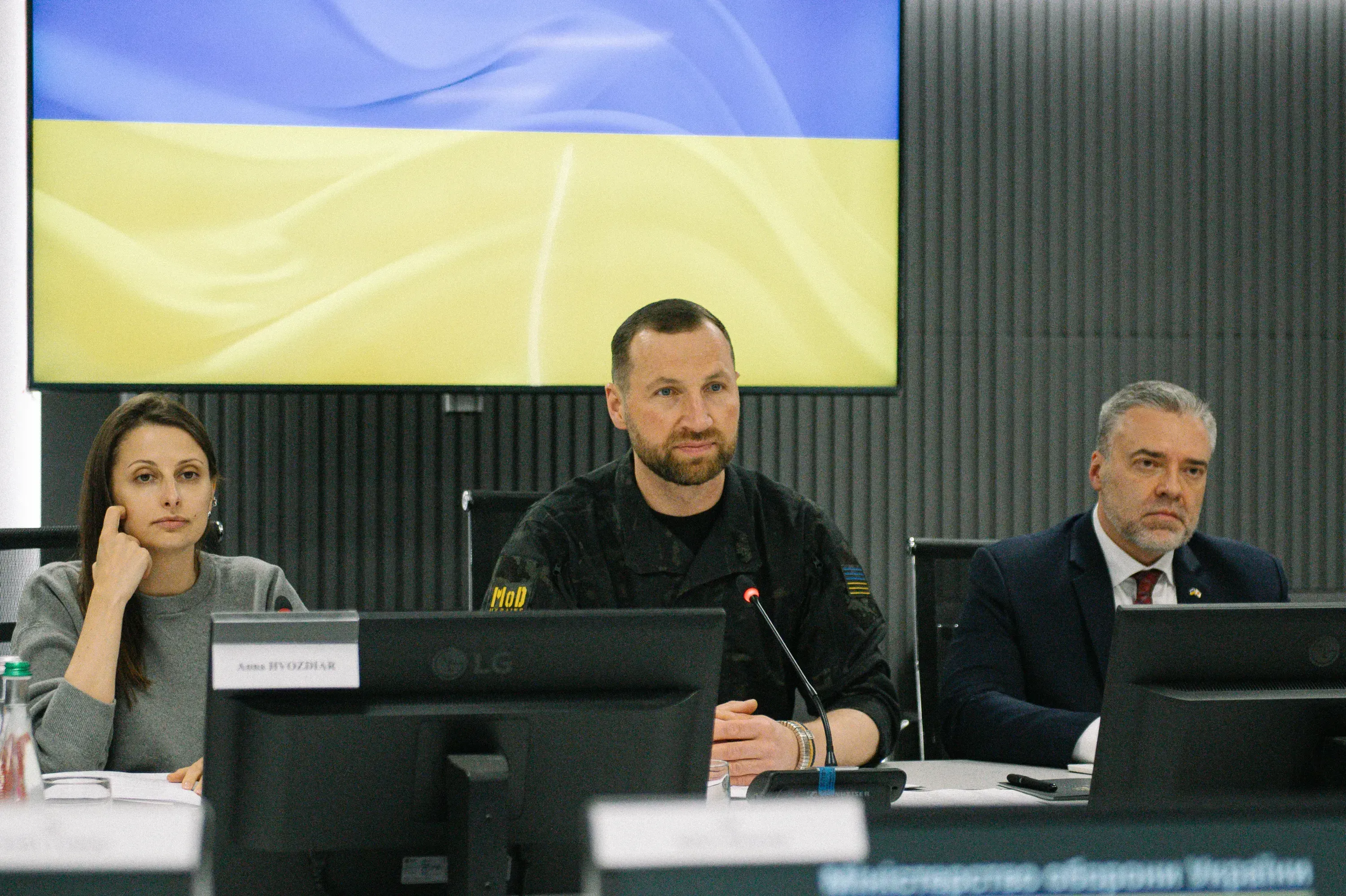 Evgeniy Khmara and members of the Ukrainian delegation seated at a table with monitors during a meeting with the Japanese delegation