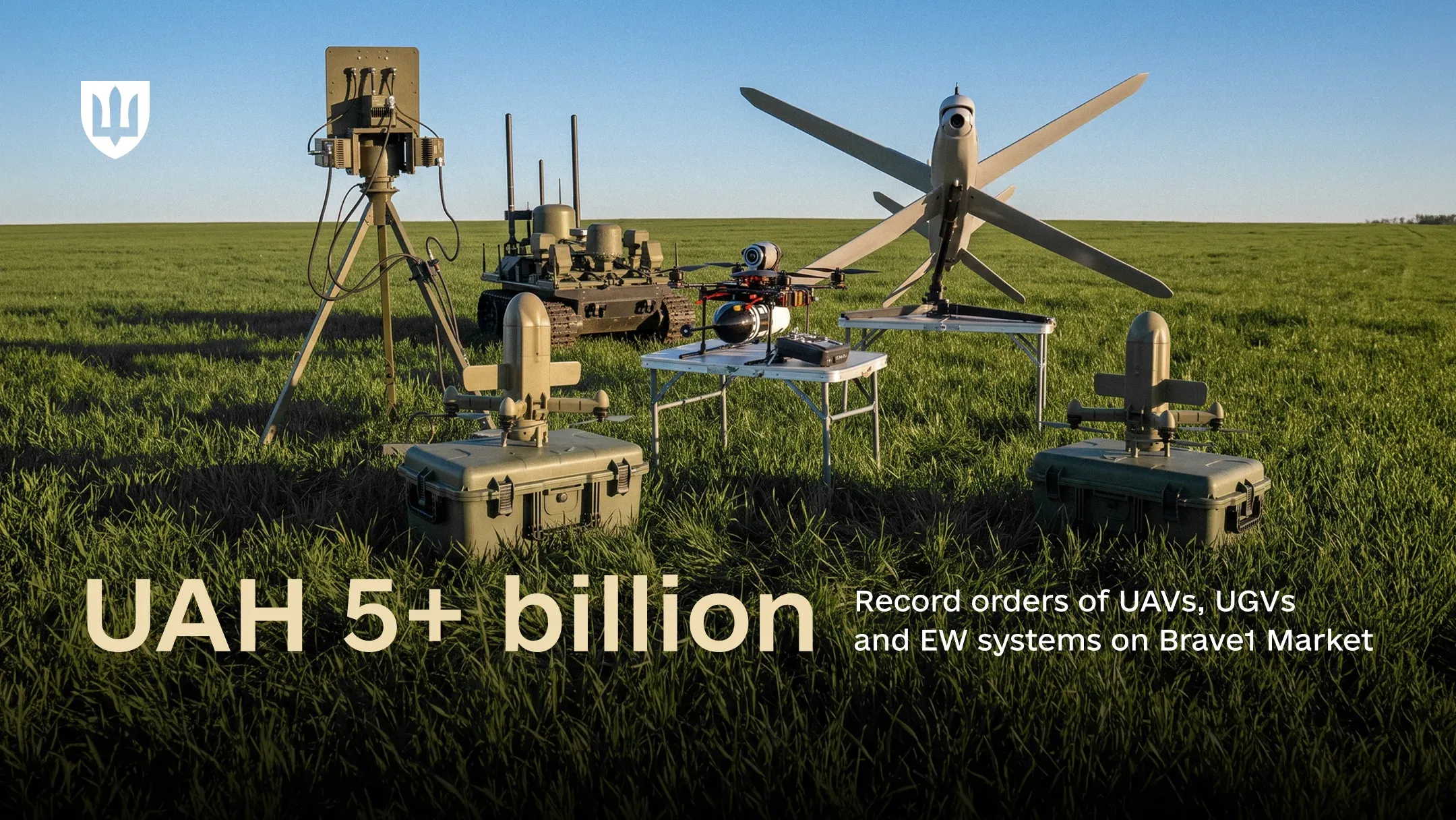 Drones, a tracked UGV and an EW antenna array displayed in a field