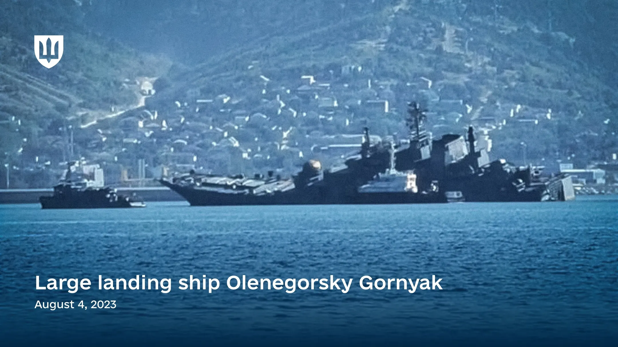 A photograph of the damaged russian Project 775 large landing ship Olenegorsky Gornyak in the Black Sea near Novorossiysk, showing a strong list to port.