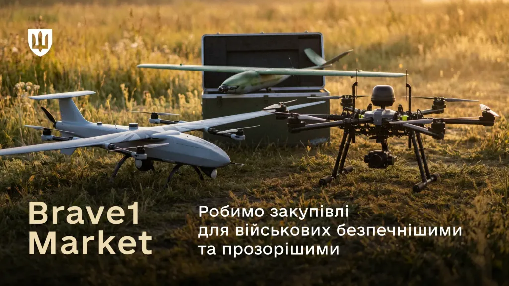 Три військові безпілотники різних типів стоять на траві поруч із відкритим транспортувальним кейсом