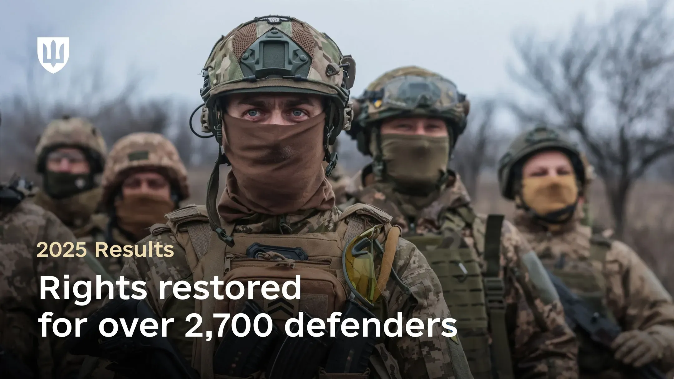 A group of Ukrainian service members in full combat gear, wearing helmets and balaclavas, is shown. Their expressions are resolute. Centered on the image is text reading: “Results for 2025. Rights restored for over 2,700 defenders”.