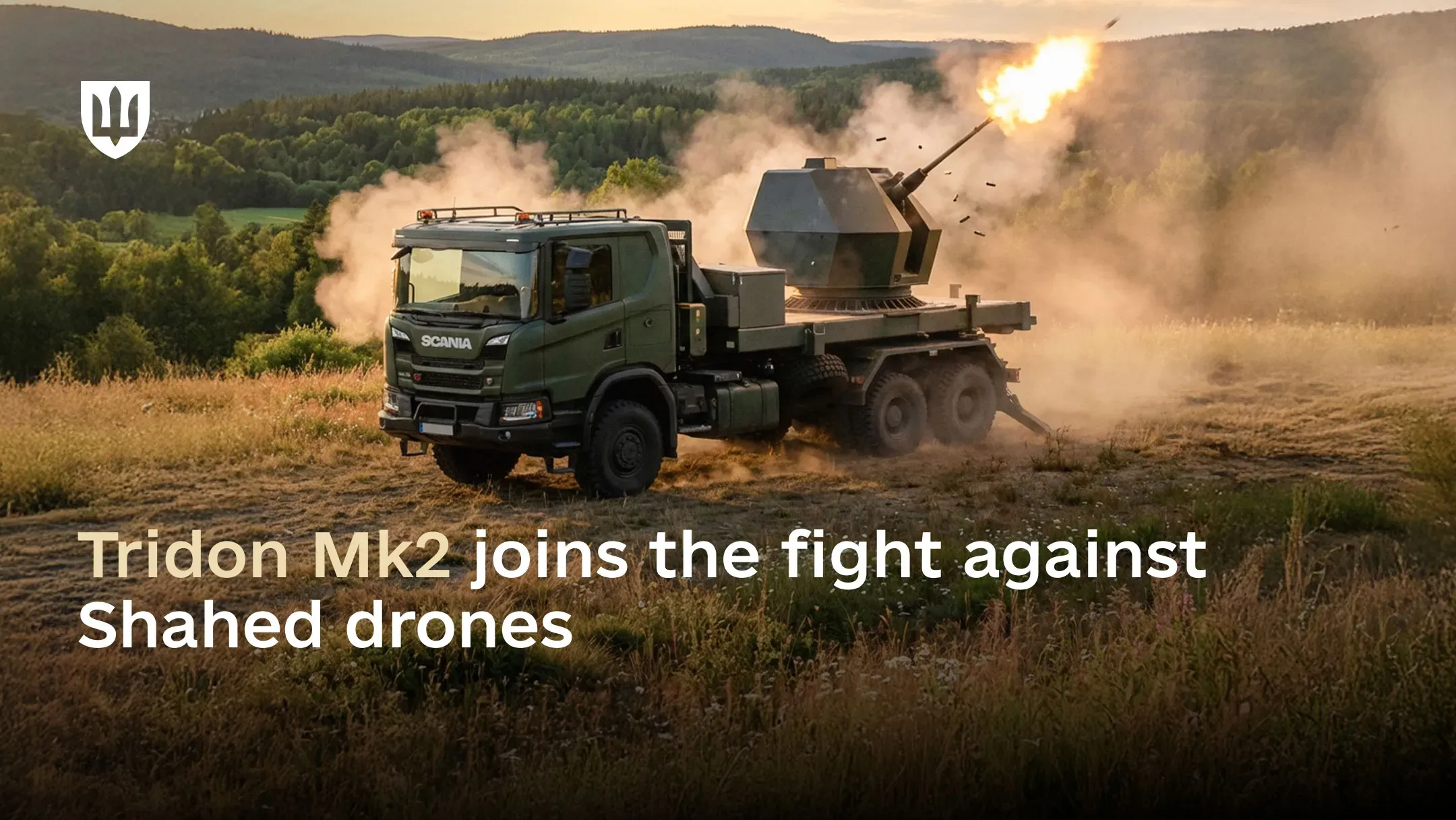 A Tridon Mk2 air defence system mounted on a Scania truck fires in open terrain with wooded hills in the background at sunset