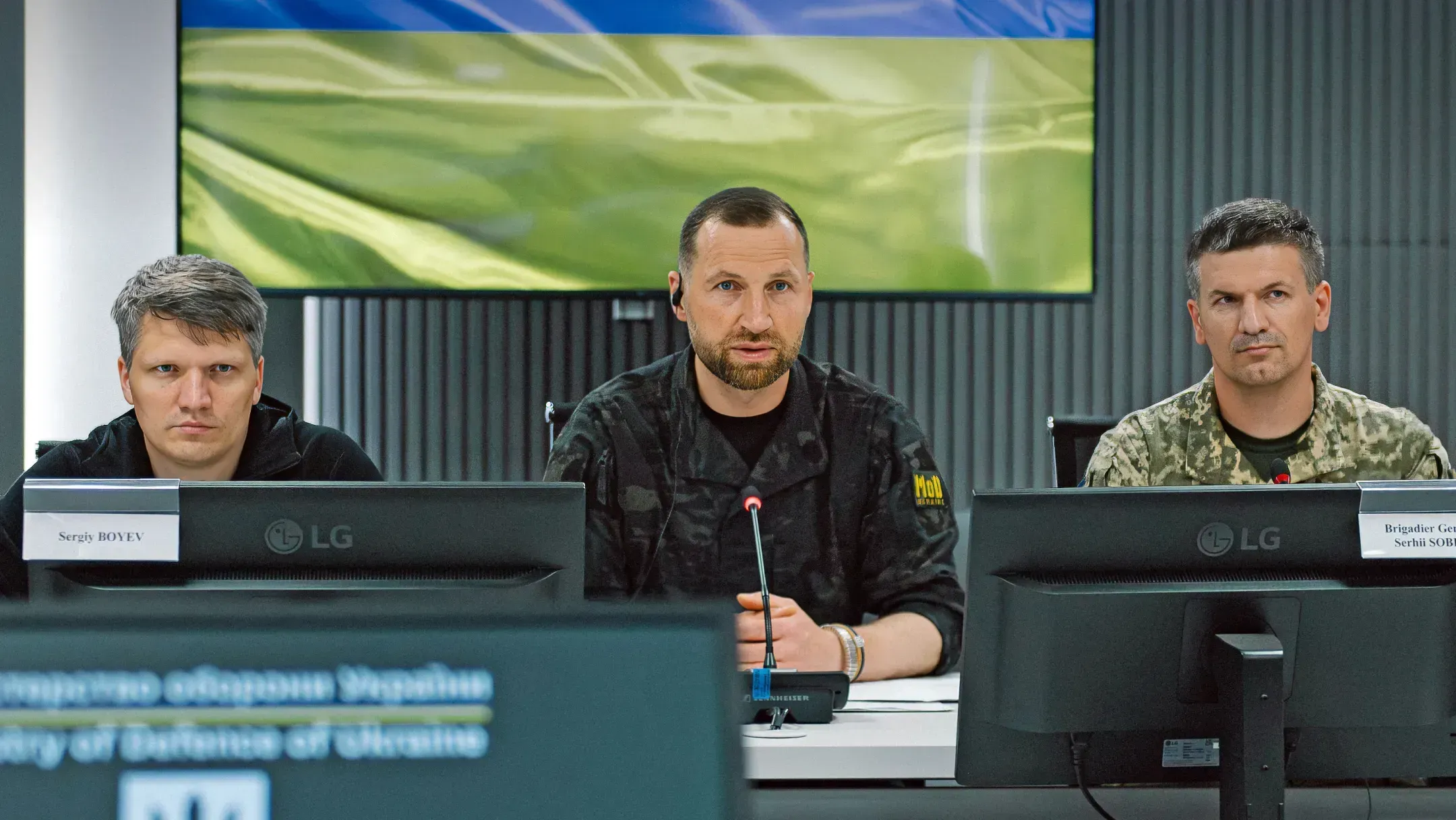 Sergiy Boyev, Evgeniy Khmara and Serhii Sobko seated at the table during the talks