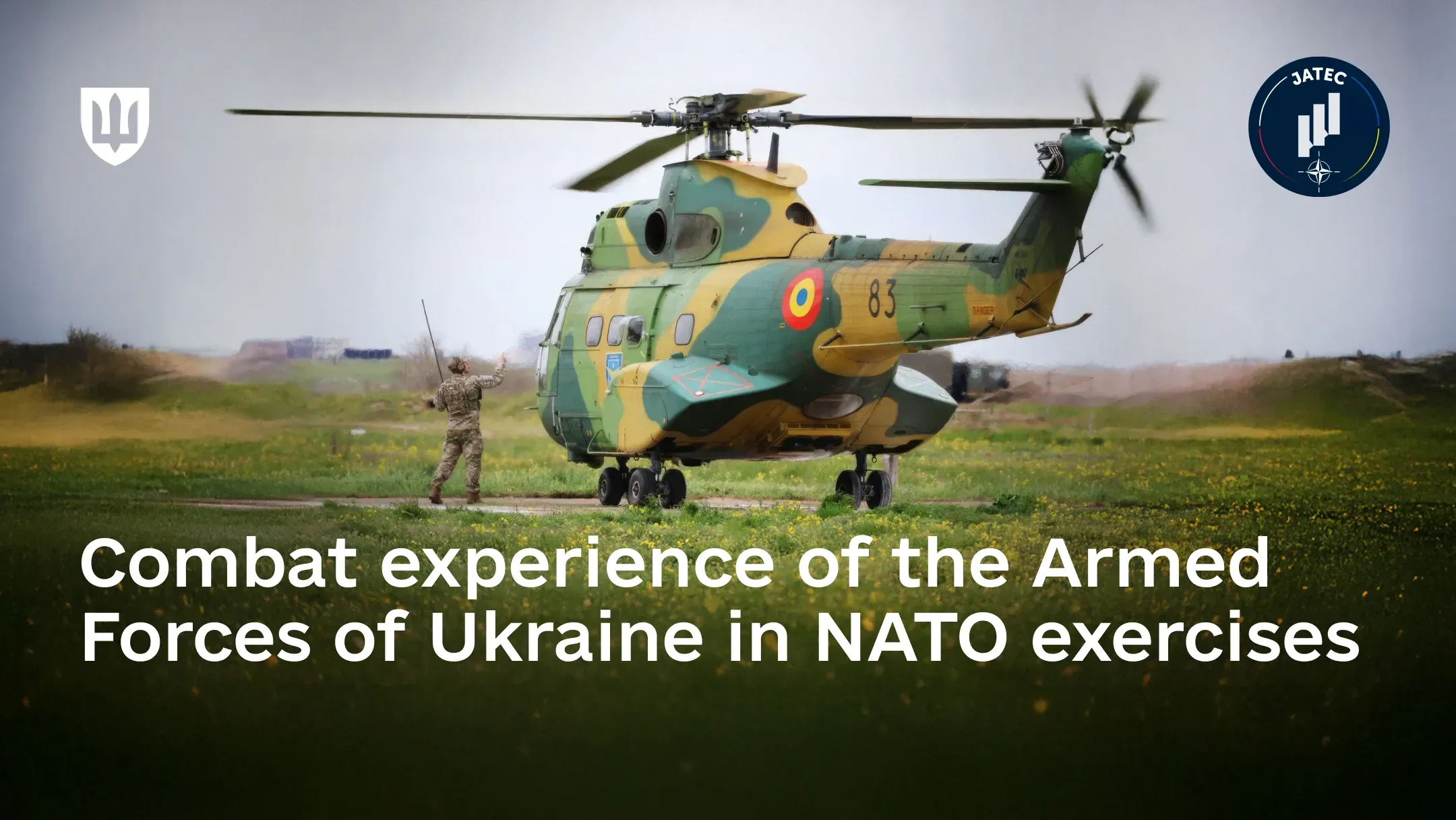 A Ukrainian service member directs a Romanian-manufactured IAR 330 Puma helicopter on a runway during NATO exercises