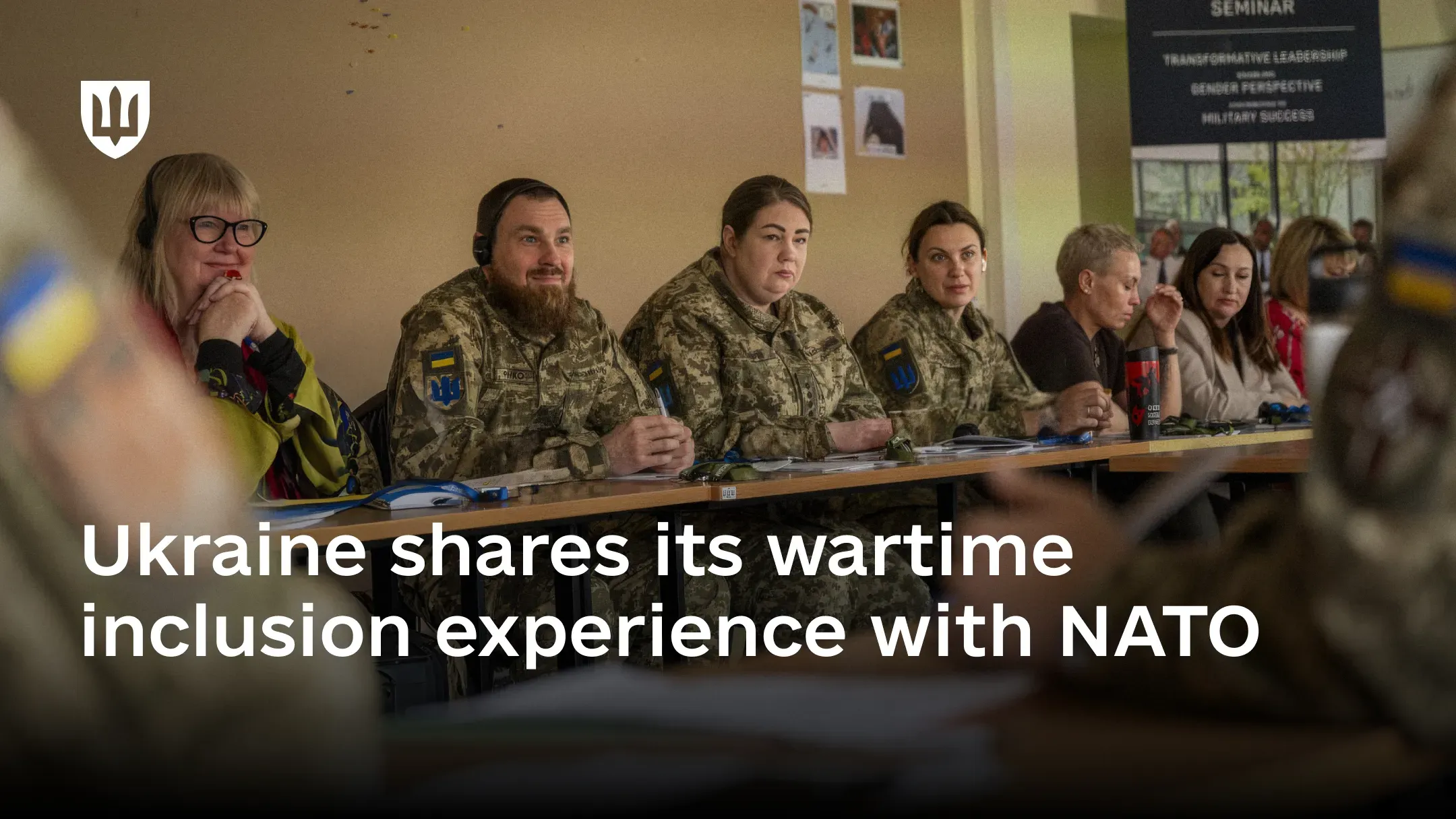 A group of service members seated at a table during a seminar in Latvia