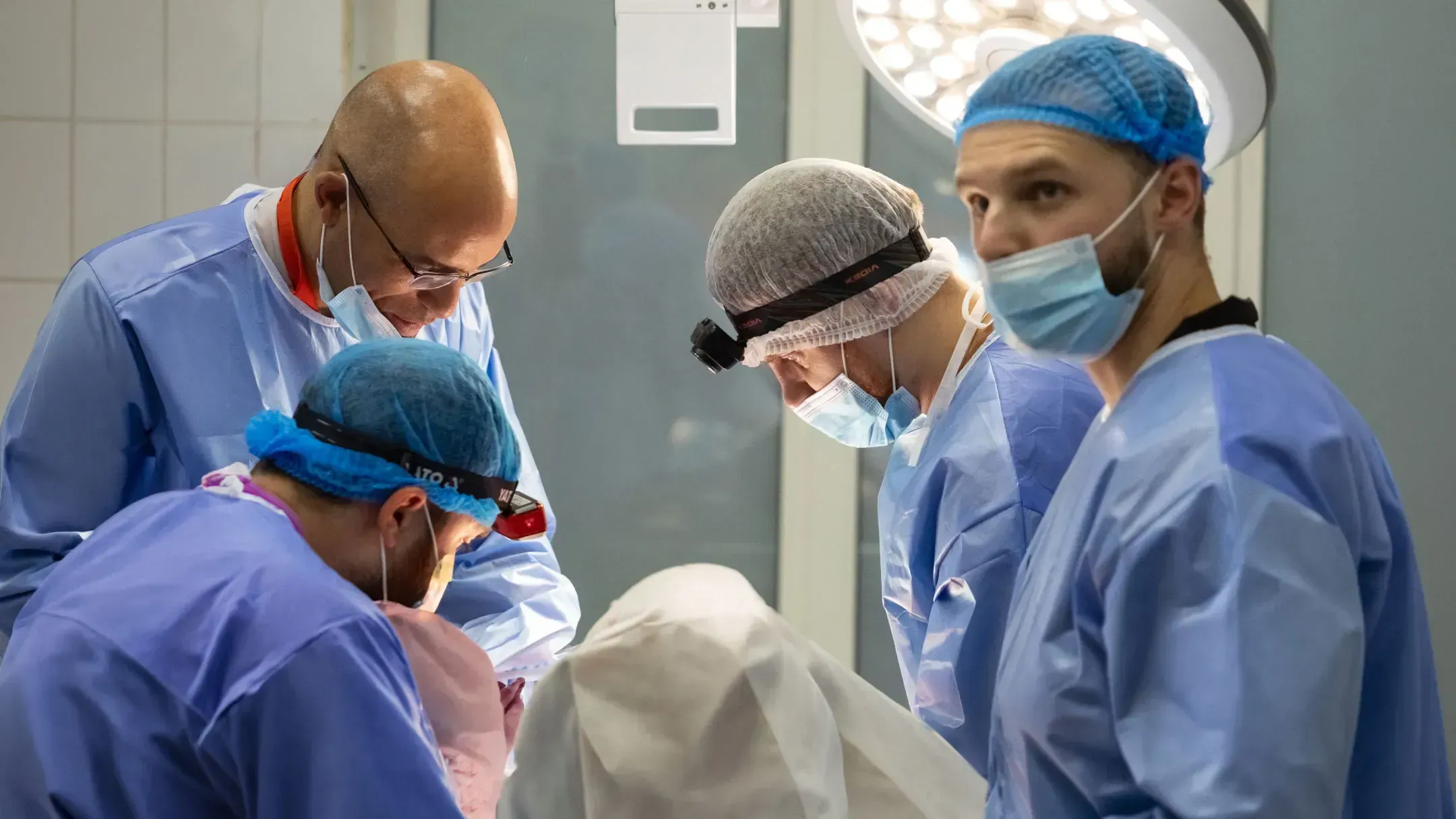 A surgical team works together during practical training in an operating room