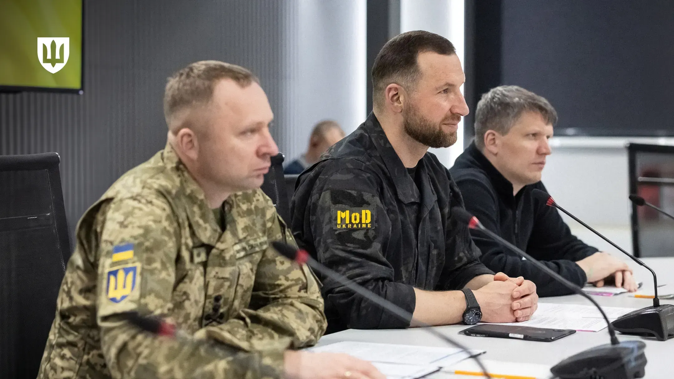 Ukrainian delegation at a table with microphones during the talks