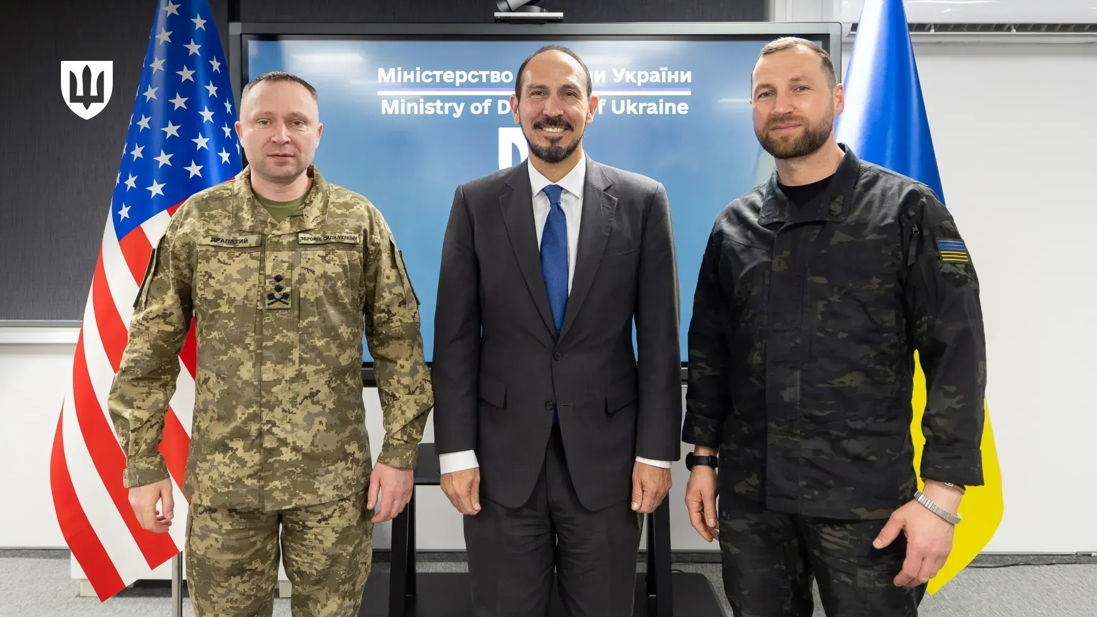 Evgeniy Khmara, Mykhailo Drapatyi and Orlando Sanchez Jr. during the meeting, with the flags of Ukraine and the United States in the background